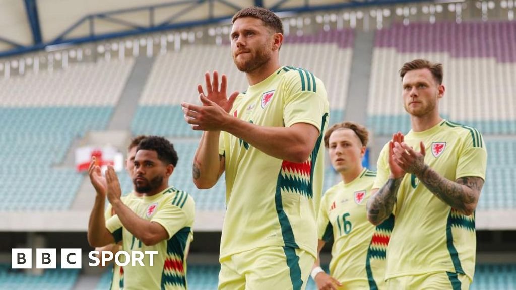 Wes Burns and team-mates applaud Wales' fans in Portugal