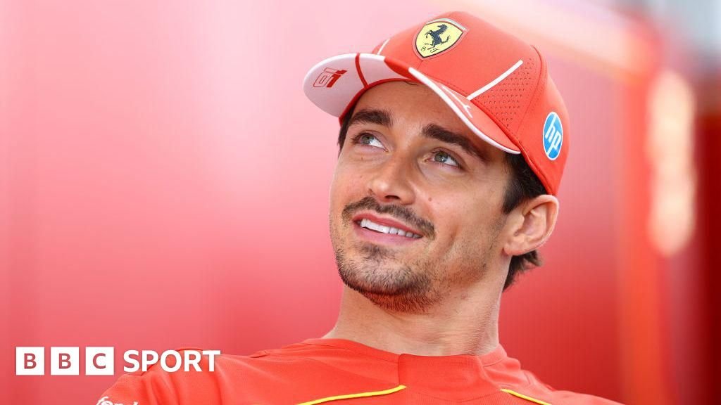 Charles Leclerc smiles and looks up