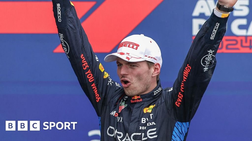 Max Verstappen holds aloft the trophy after winning the Canadian Grand Prix