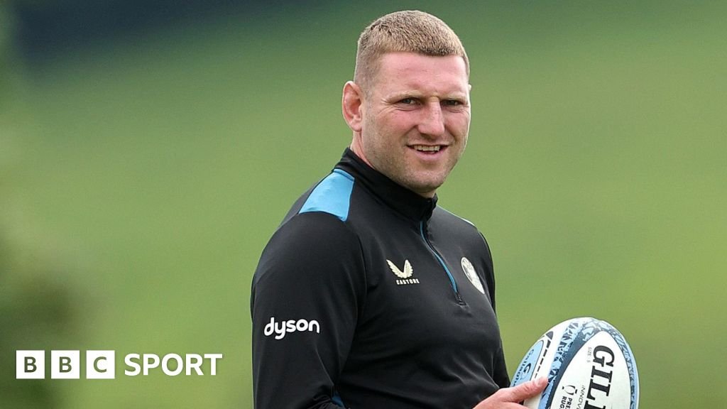 Finn Russell holds a rugby ball during training