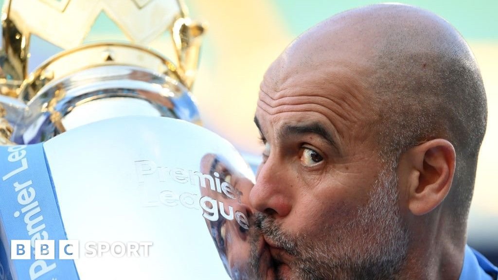 Manchester City manager Pep Guardiola kisses the Premier League trophy